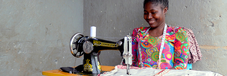 Gloria Smiling with her sewing machine